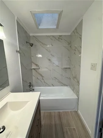 a bathroom with a sink a bathtub and a shower