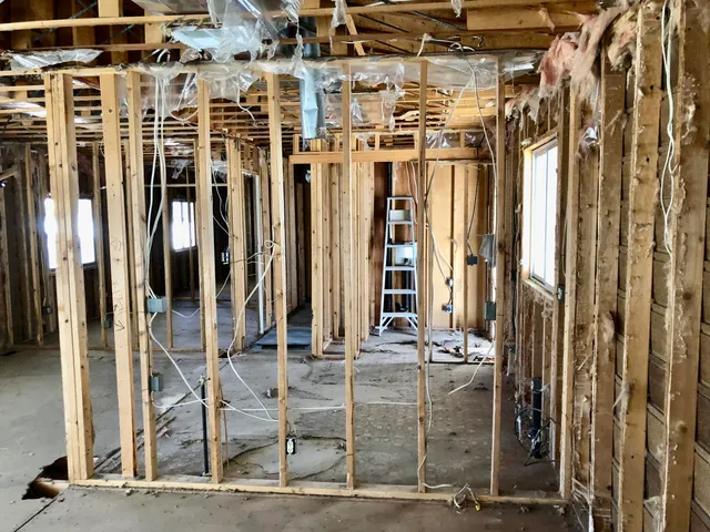 a view of a room with wooden floor and windows
