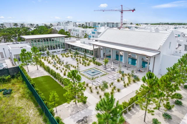 a view of a swimming pool with a patio and a yard