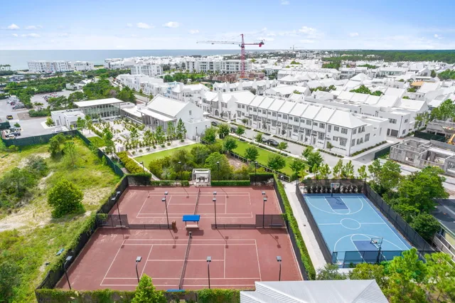 an aerial view of multiple houses with yard