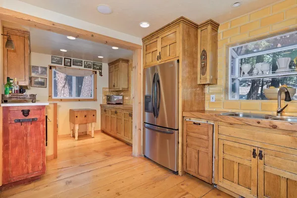 a kitchen with stainless steel appliances granite countertop a refrigerator and a sink