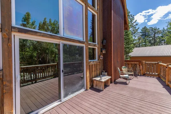 a view of a balcony with chairs and wooden floor
