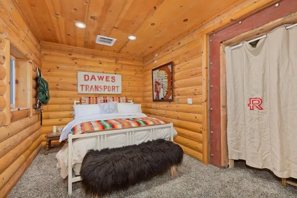 a bedroom with a bed and a television