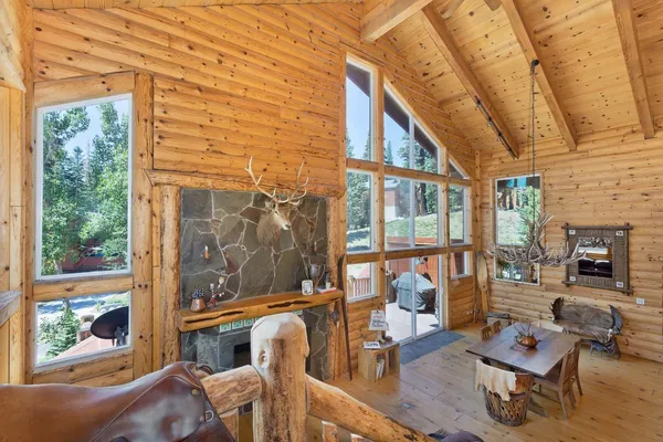 a living room with fireplace furniture and a floor to ceiling window