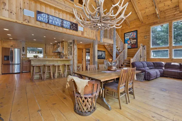a view of a dining room with furniture wooden floor and chandelier