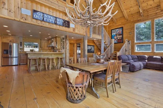 a view of a dining room with furniture wooden floor and chandelier