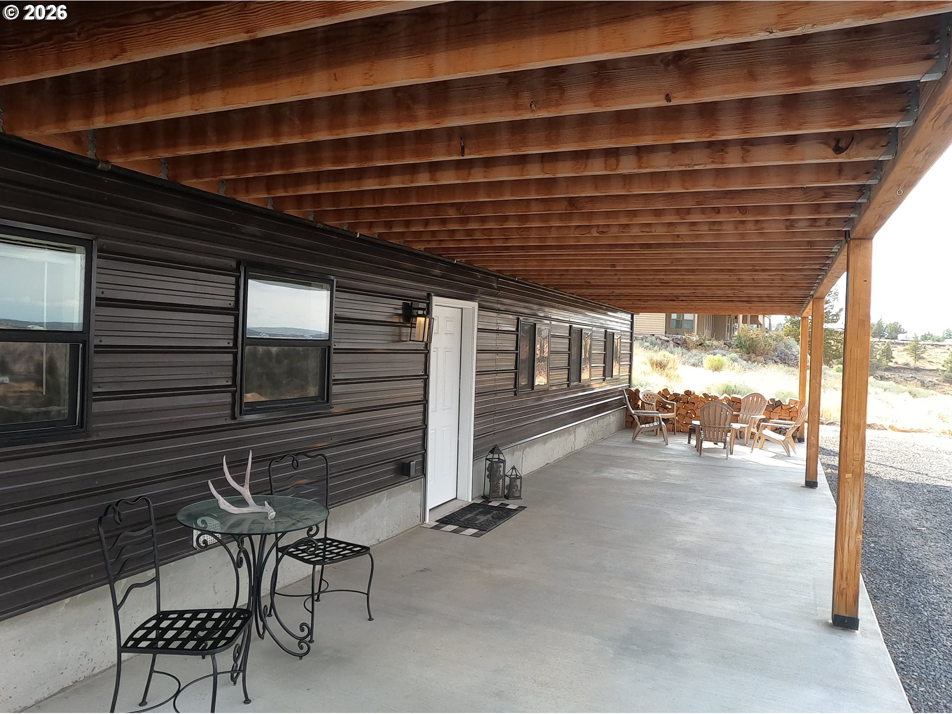 4463 Southwest Corral Drive Culver, OR 97734 - Photo 11 of 39 a roof deck with table and chairs and potted plants