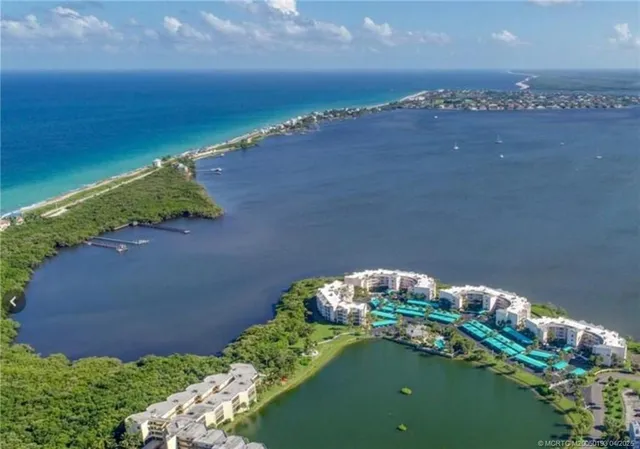 an aerial view of residential houses with outdoor space and swimming pool