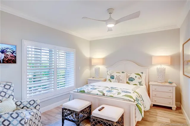 a bedroom with a bed and a large window with the outer view