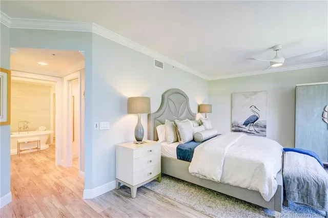 a living room filled with furniture and a potted plant