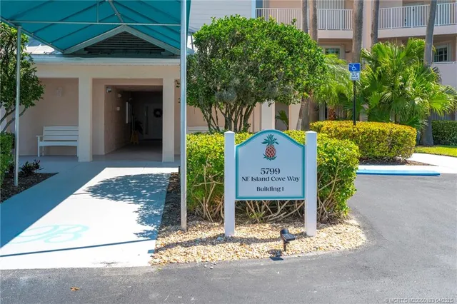 a dining room with furniture potted plants and wooden floor