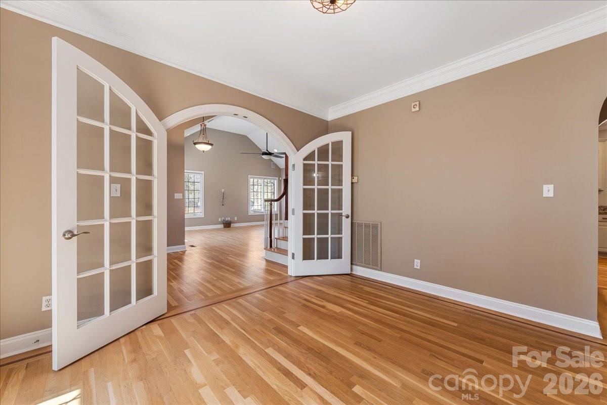 8380 Rocky River Road Harrisburg, NC 28075 - Photo 20 of 47 an empty room with wooden floor and windows
