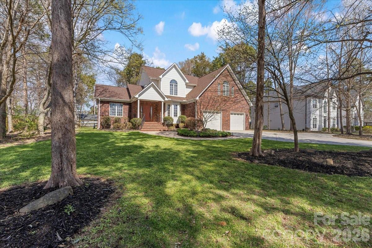 8380 Rocky River Road Harrisburg, NC 28075 - Photo 2 of 47 a front view of a house with a yard
