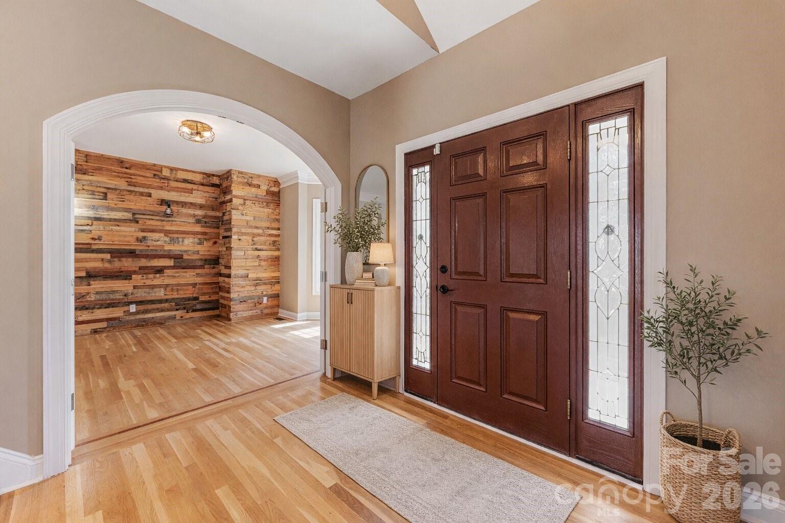 8380 Rocky River Road Harrisburg, NC 28075 - Photo 4 of 47 a view of a hallway with wooden floor and a living room