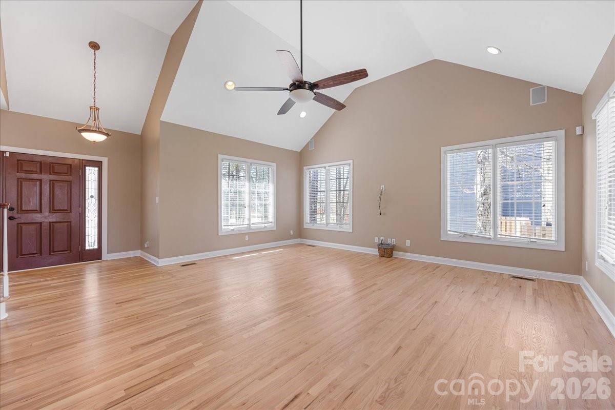 8380 Rocky River Road Harrisburg, NC 28075 - Photo 6 of 47 a view of an empty room with wooden floor and a window