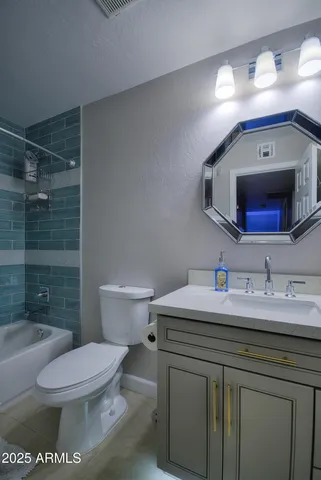 a bathroom with a sink a toilet and a mirror