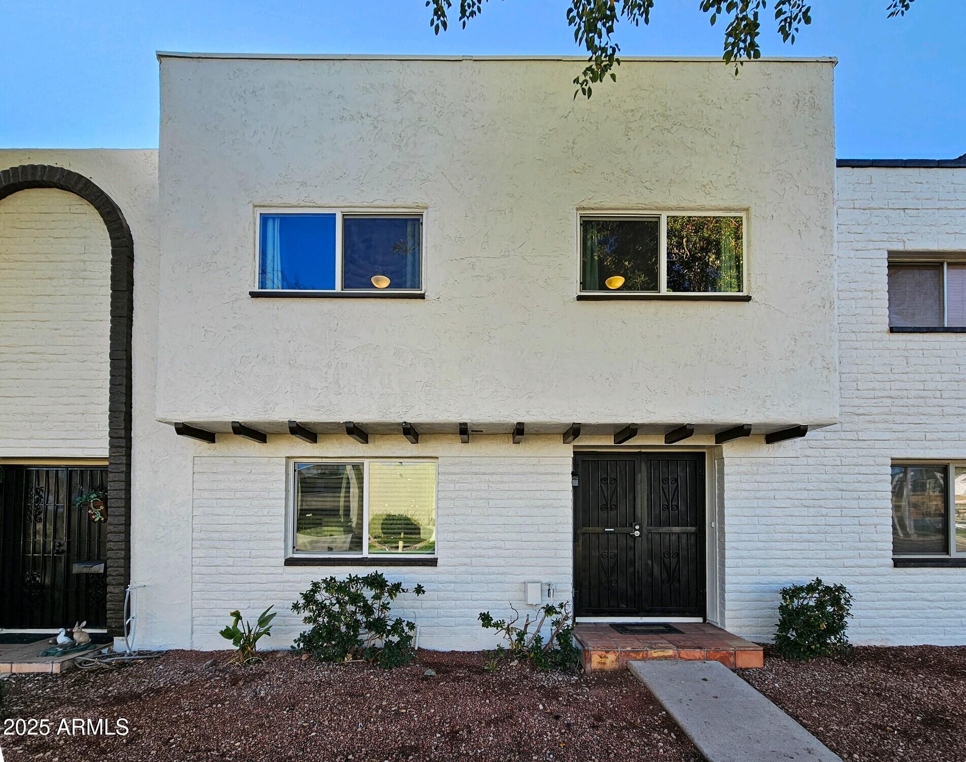 7603 East Montecito Avenue Scottsdale, AZ 85251 - Photo 21 of 21 a front view of a house with garden