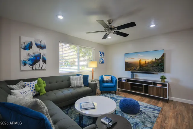 a living room with furniture a rug and a flat screen tv