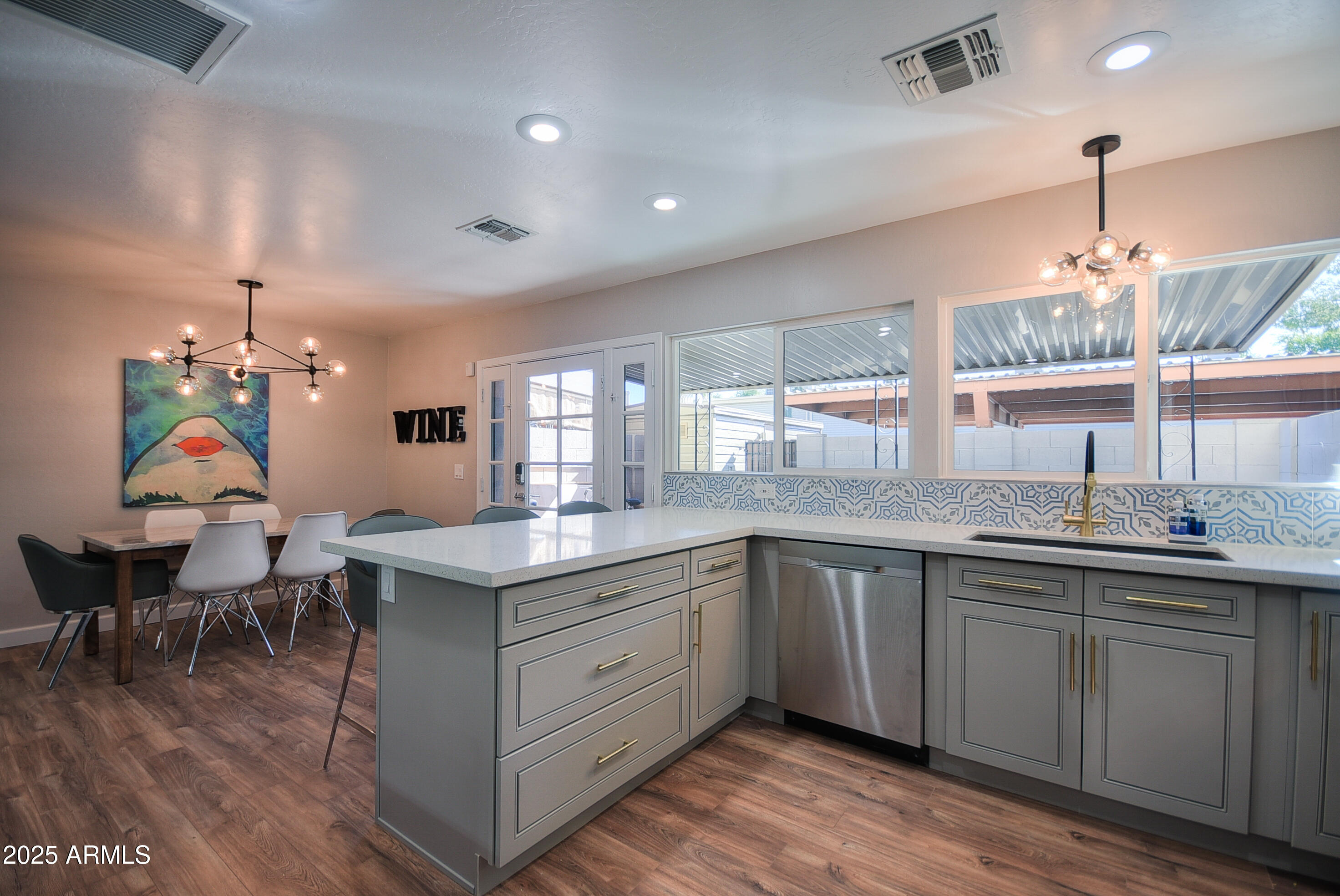 7603 East Montecito Avenue Scottsdale, AZ 85251 - Photo 5 of 21 a very nice looking kitchen with a center island wooden floor and a sink