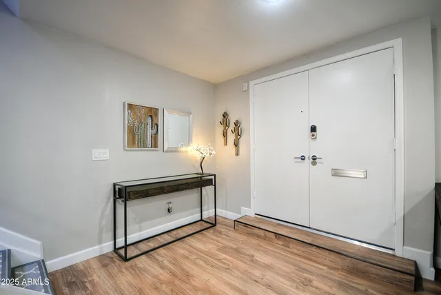 a view of a small space with wooden floor and a window