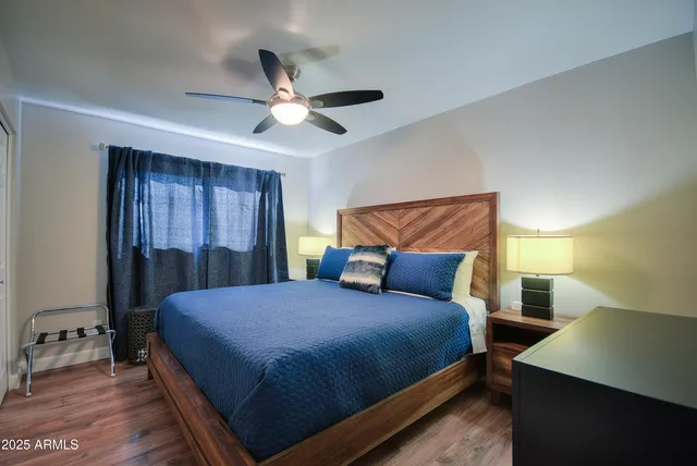 a bedroom with a large bed and a chandelier