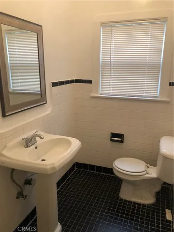 a bathroom with a sink toilet and mirror