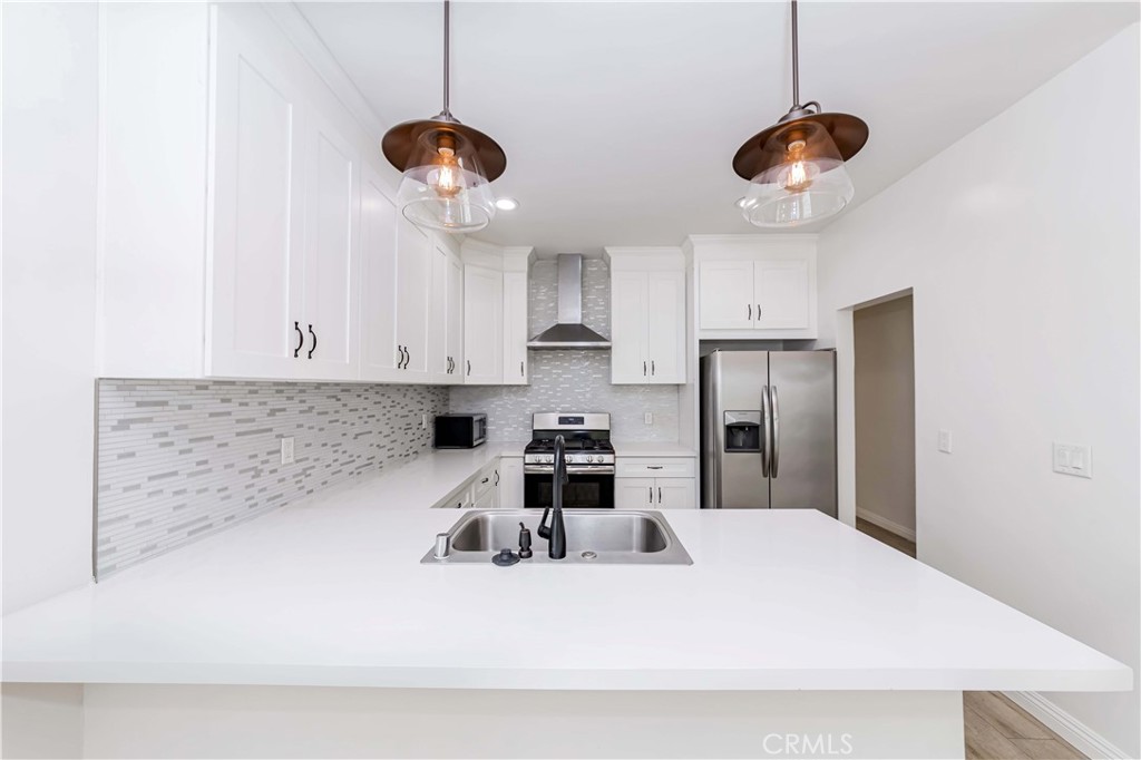 351 North Spaulding Avenue Los Angeles, CA 90036 - Photo 2 of 31 a kitchen with stainless steel appliances a stove a refrigerator and cabinets