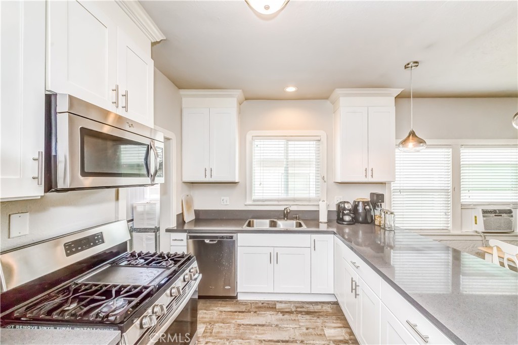 351 North Spaulding Avenue Los Angeles, CA 90036 - Photo 26 of 31 a kitchen with a sink stove top oven and cabinets