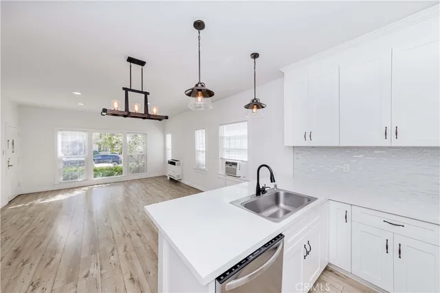 a kitchen with a sink window and cabinets