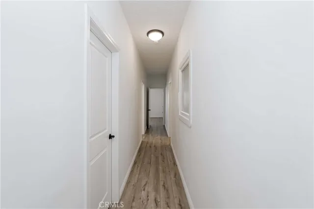 a view of a hallway with wooden floor