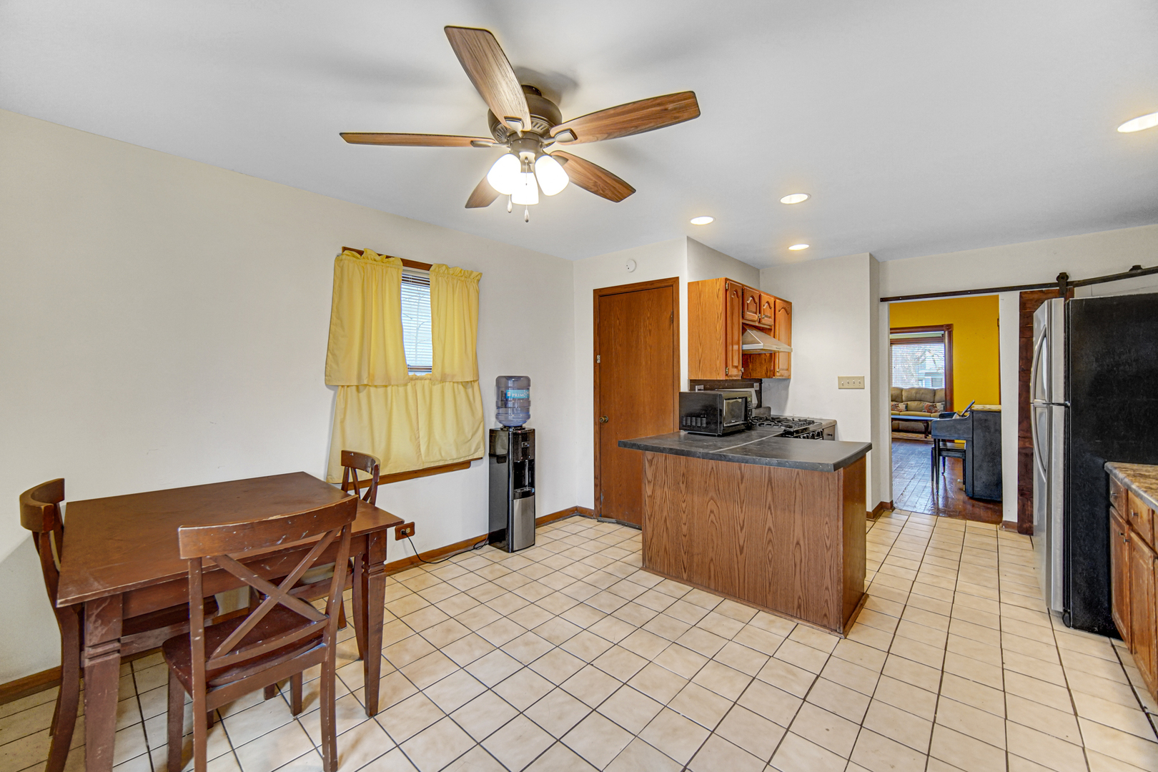 1112 South Jefferson Street Lockport, IL 60441 - Photo 12 of 21 a kitchen with stainless steel appliances kitchen island granite countertop dining table chairs and a refrigerator