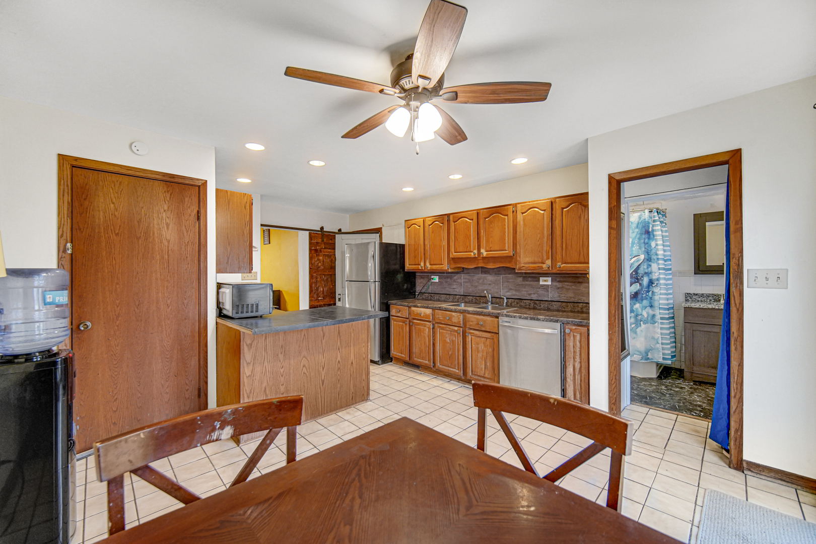 1112 South Jefferson Street Lockport, IL 60441 - Photo 13 of 21 a kitchen with stainless steel appliances kitchen island granite countertop a refrigerator a stove and white cabinets with wooden floor