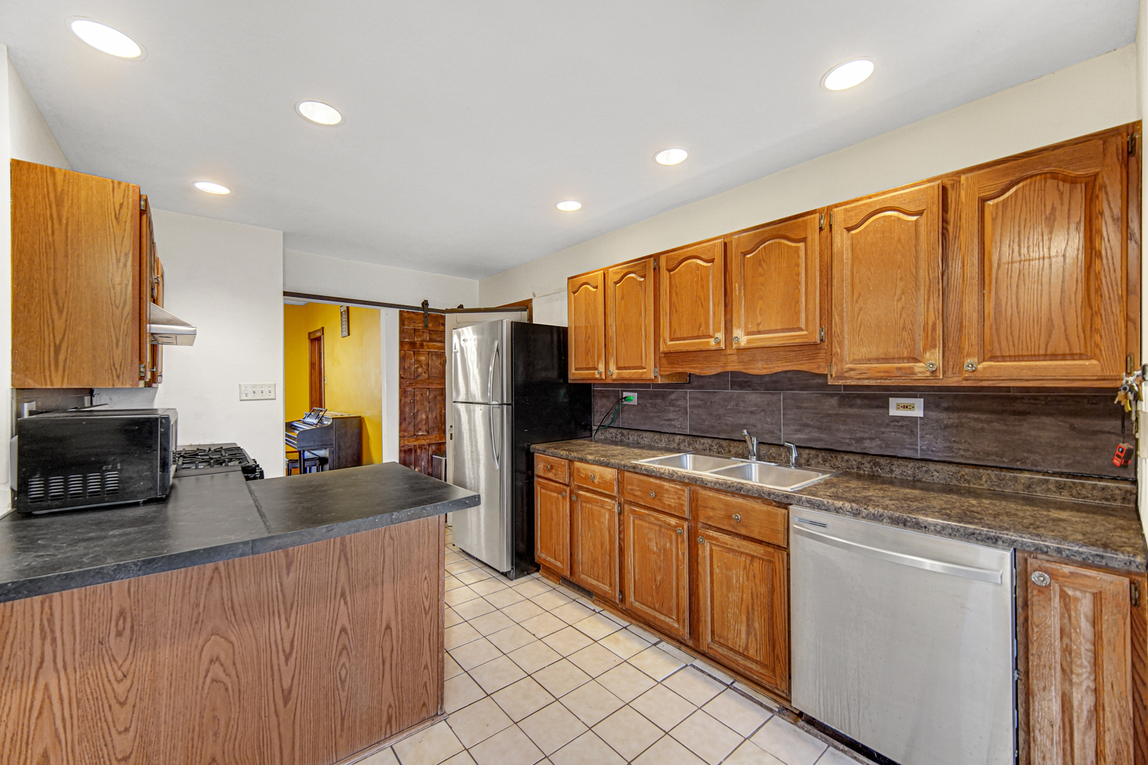1112 South Jefferson Street Lockport, IL 60441 - Photo 14 of 21 a kitchen with stainless steel appliances granite countertop a stove a sink and a refrigerator