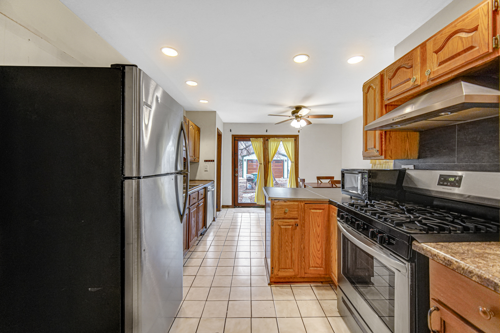 1112 South Jefferson Street Lockport, IL 60441 - Photo 15 of 21 a kitchen with stainless steel appliances granite countertop a refrigerator a stove and a sink