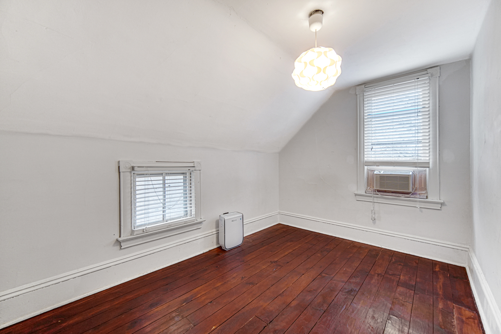 1112 South Jefferson Street Lockport, IL 60441 - Photo 18 of 21 an empty room with wooden floor chandelier and windows