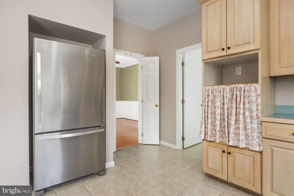 a view of kitchen with refrigerator and cabinet