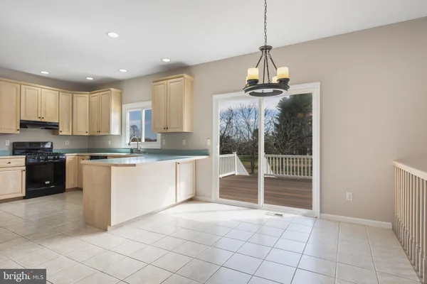 a kitchen with kitchen island granite countertop a stove a sink and a granite counter tops
