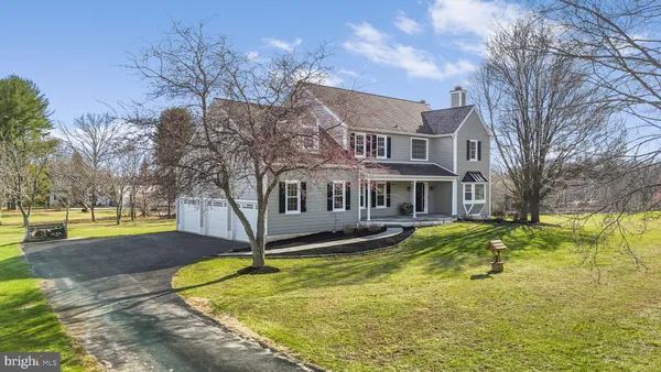 a front view of a house with swimming pool and yard