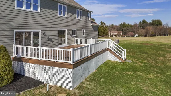 a view of a house with a small yard and wooden fence