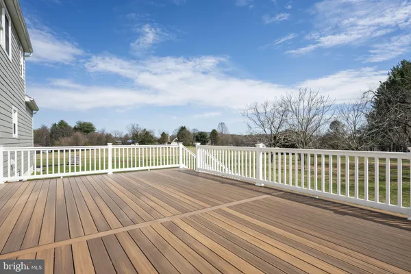 a view of deck with wooden floor and fence