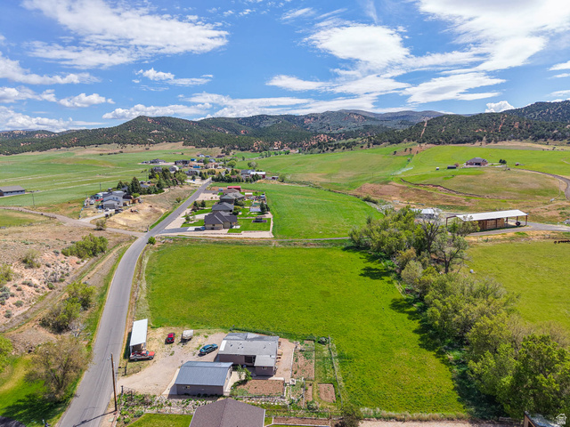 94 Spring Canyon Road Coalville, UT 84017 - Photo 1 of 50 Expansive green acreage featuring a residential structure with a light grey exterior and dark grey roof