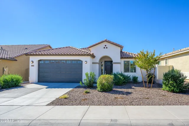 a front view of a house with a yard and garage
