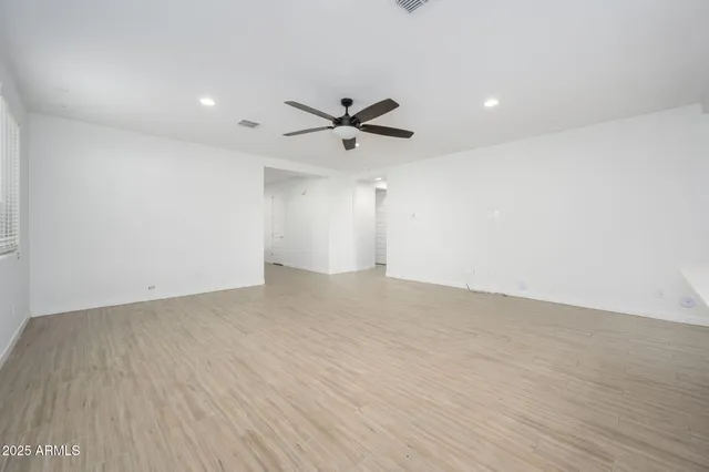 a open kitchen with stainless steel appliances granite countertop a stove a sink dishwasher a refrigerator and a oven with wooden floor