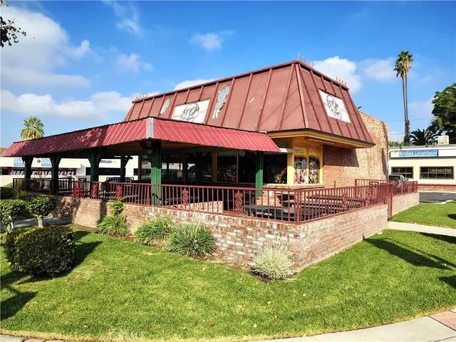 a patio with a table and chairs under an umbrella