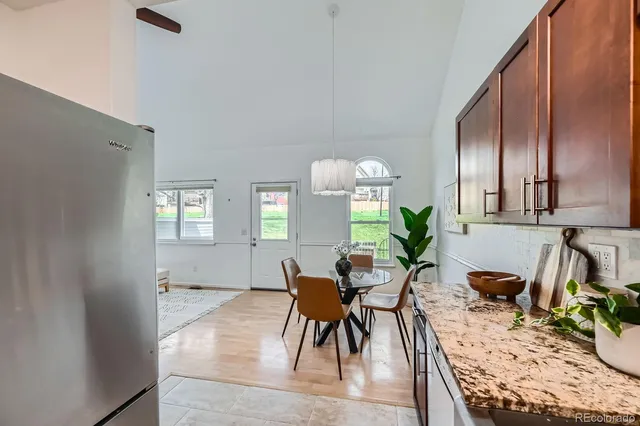 a view of a a dining room with furniture window and wooden floor
