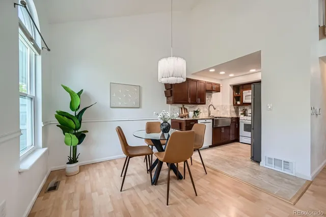 a view of a dining room with furniture window and wooden floor