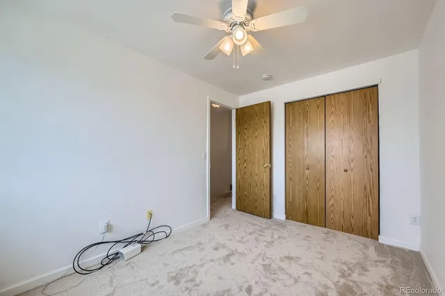a view of a livingroom with a chandelier fan
