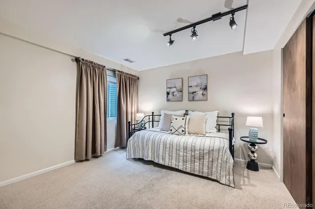 a bedroom with a bed and a chandelier