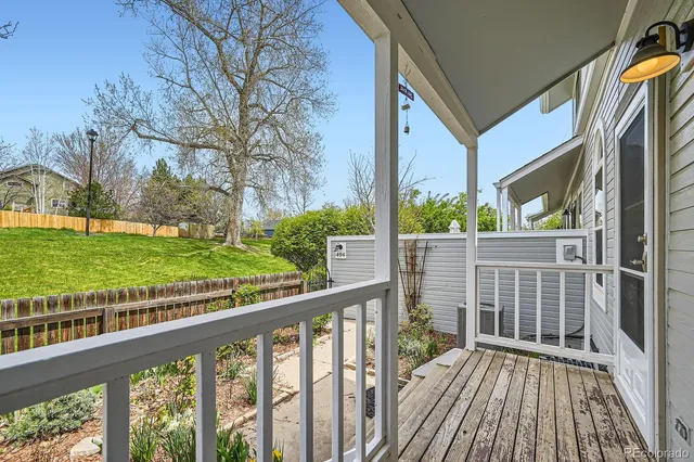 a view of a balcony with yard