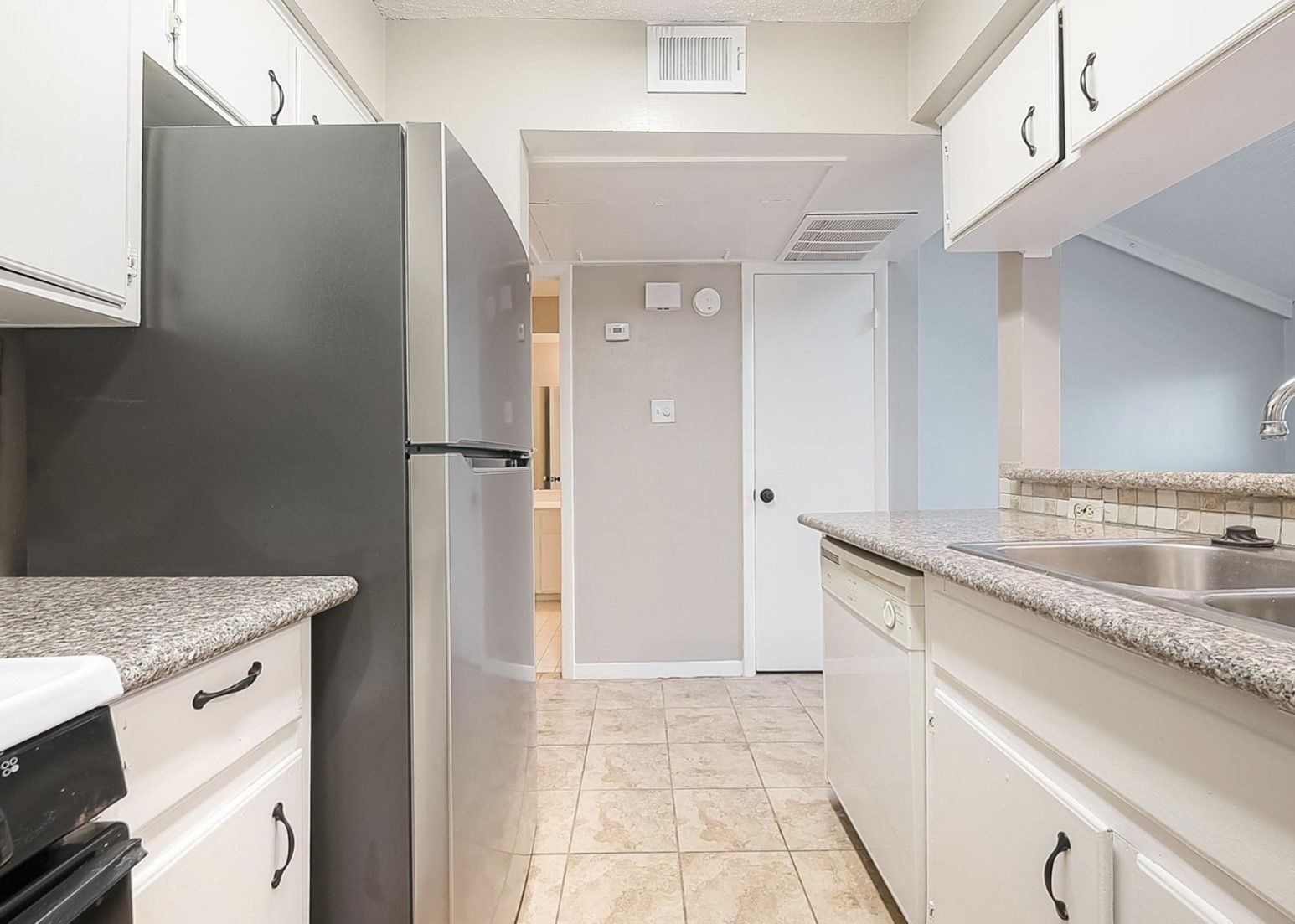 1108 West Tri Oaks Lane, Unit 150 Houston, TX 77043 - Photo 11 of 26 a kitchen with a sink stove and refrigerator